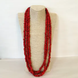 Extra long vintage necklace of triple strand of coral texture beads.