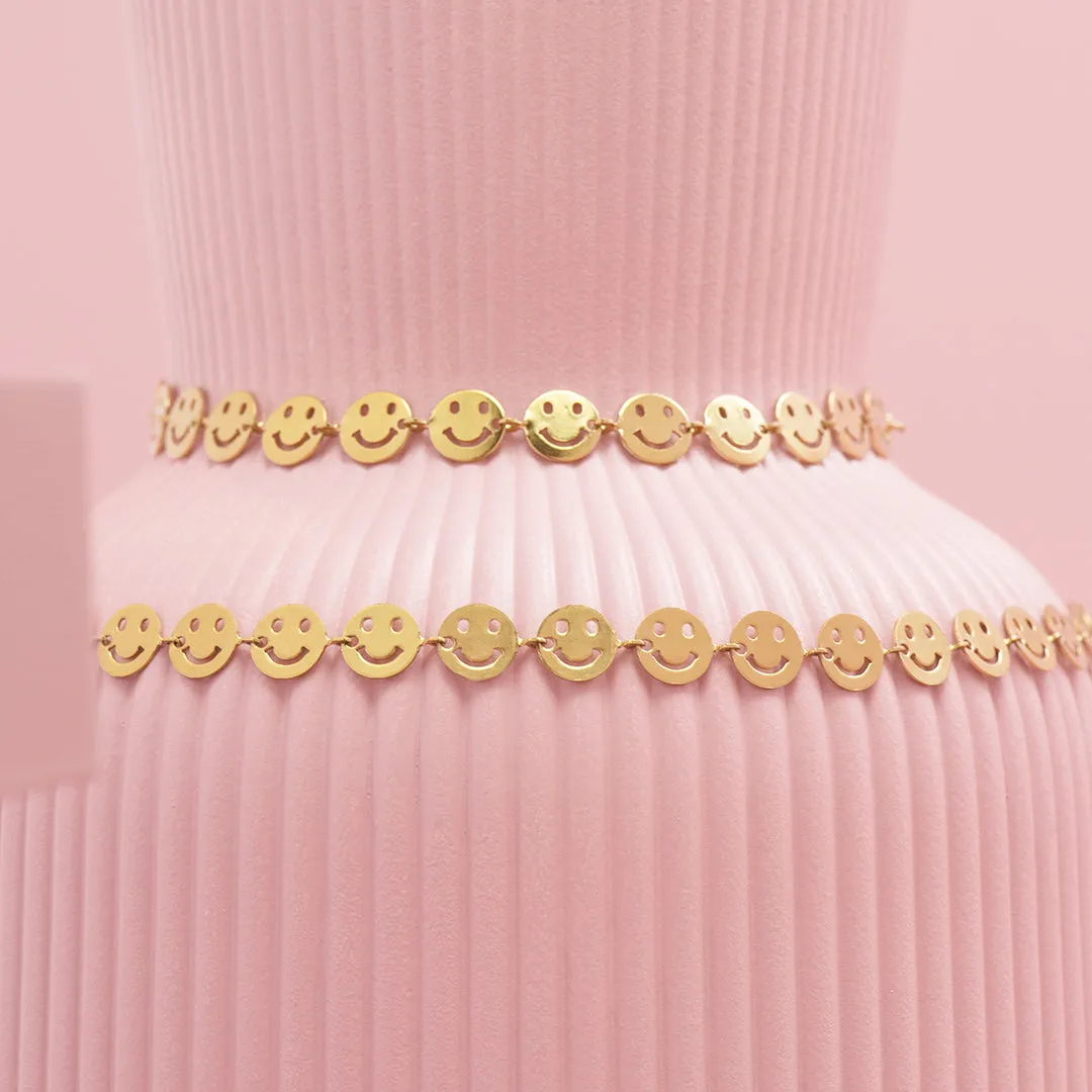 Gold coloured bracelet   necklace set with smileys